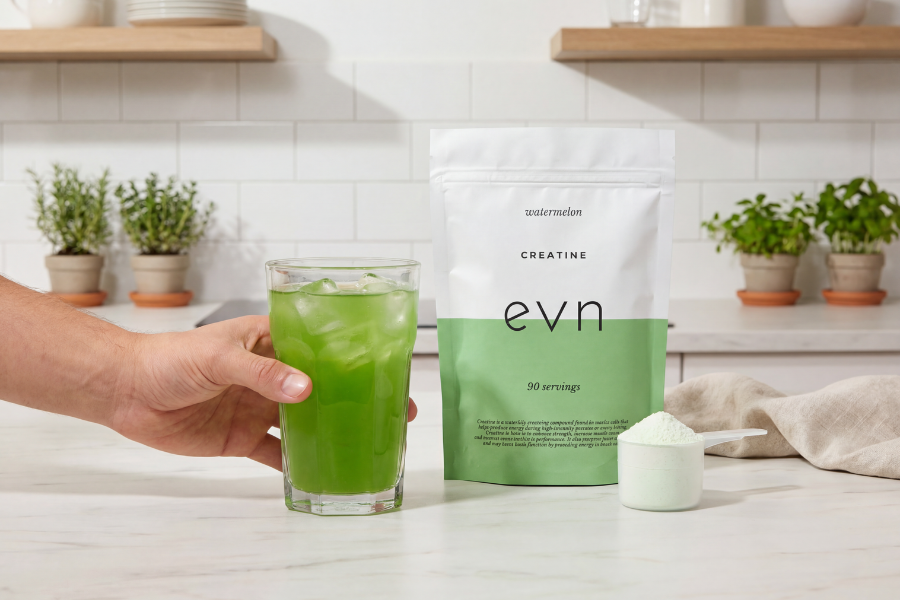 creatine drink with a scoop of powder next to it